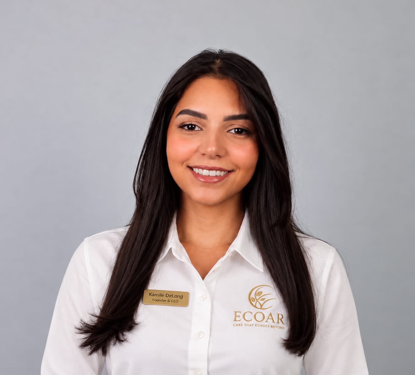Portrait in a white ECOAR shirt with a name badge reading Kamile DeLong, Founder & CEO